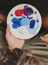 Close-up of hand holding ice cream