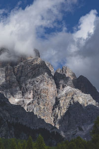 Low angle view of rocky mountains against sky