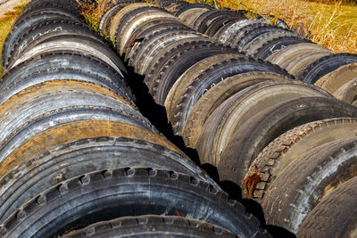High angle view of abandoned rubber tires on field