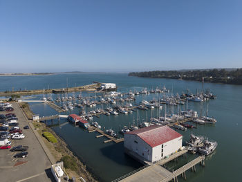 High angle view of townscape by sea against clear sky