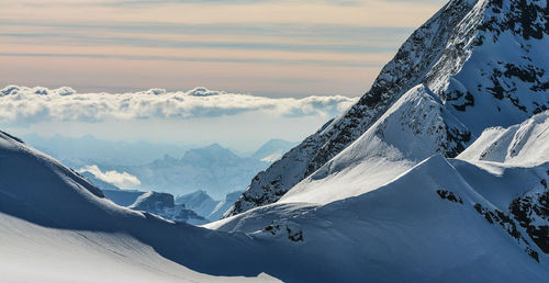 Scenic view of snow covered mountains against sky