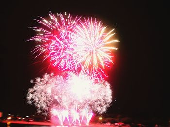 Low angle view of firework display at night