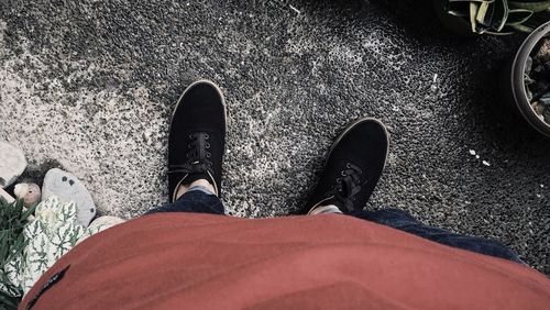Low section of man standing on road
