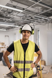 Portrait of smiling man standing in hat