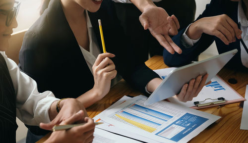 Midsection of business people working at office