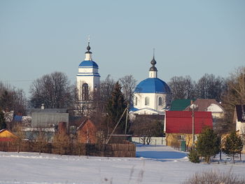 View of buildings against clear sky during winter
