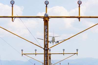 Low angle view of crane against sky