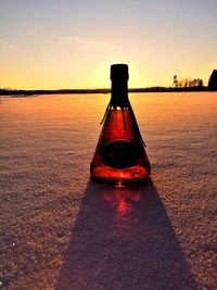 Red floating on water against sky during sunset