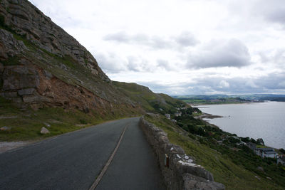 Road by mountain against sky