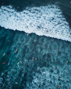 High angle view of people swimming in sea