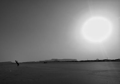 Scenic view of silhouette landscape against bright sun