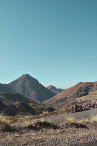 Scenic view of mountains against clear blue sky