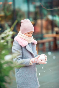 Side view of woman standing in park during winter