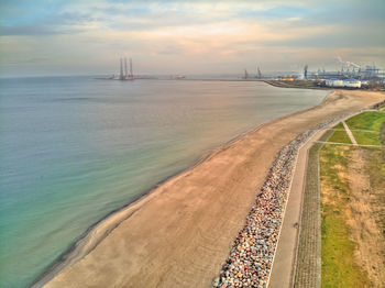 Scenic view of beach against sky during sunset