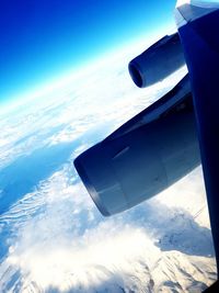 Close-up of airplane wing against sky