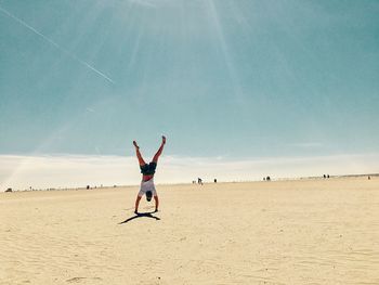 Full length of man jumping on beach