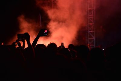 Silhouette of people at music concert