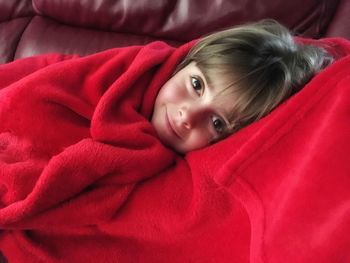 High angle portrait of cute baby relaxing on bed at home