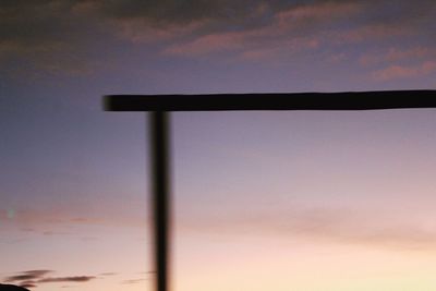 Silhouette cross against sky during sunset