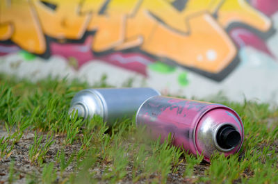 Close-up of bottles on field