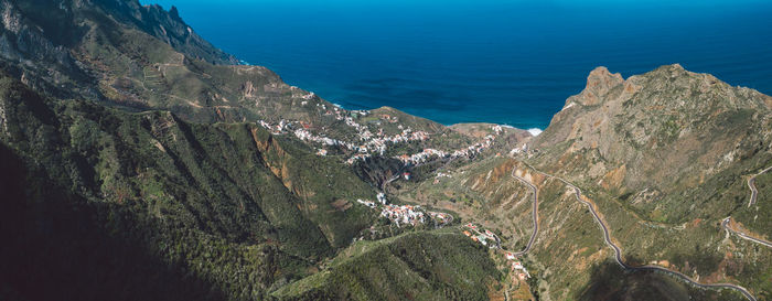 High angle view of panoramic shot of sea and mountains