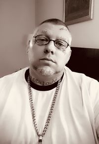 Portrait of young man wearing eyeglasses at home