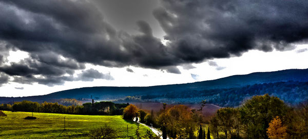 Scenic view of mountains against cloudy sky