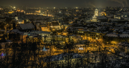 High angle view of illuminated city buildings at night