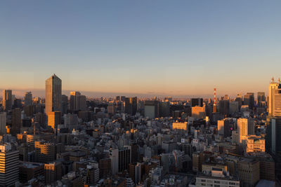 Cityscape against clear sky during sunset