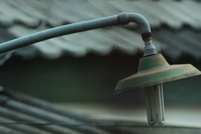 Close-up of metal on railing against blurred background