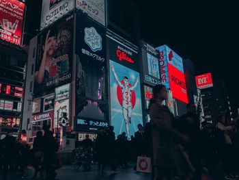 People on illuminated city at night