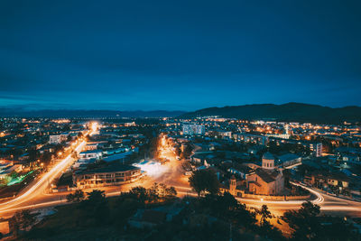 High angle view of illuminated buildings in city at night