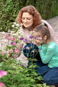 Mom and daughter walk in the park and look at flowers. allergy