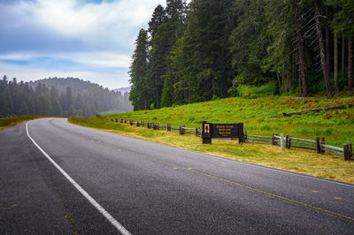 Road amidst trees against sky