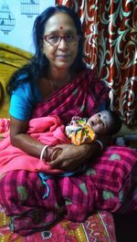 Portrait of smiling girl sitting on sofa