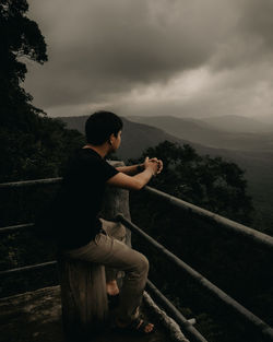 Side view of young man looking at view