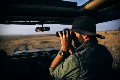 Rear view of man driving car