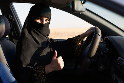 Portrait of woman sitting in car