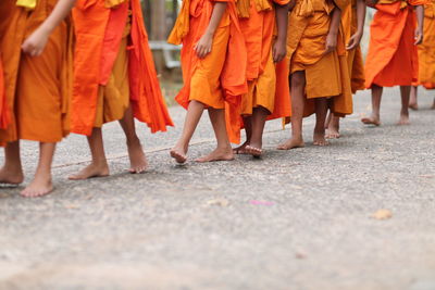 Low section of women standing on street