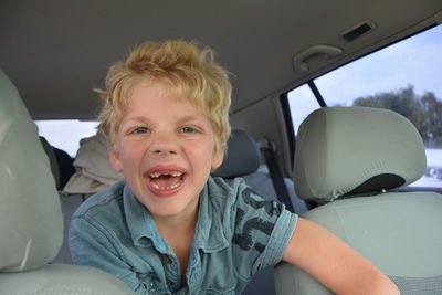 Portrait of boy sitting in car