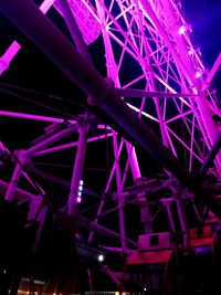 Low angle view of illuminated ferris wheel at night