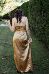 Rear view of woman standing on grass