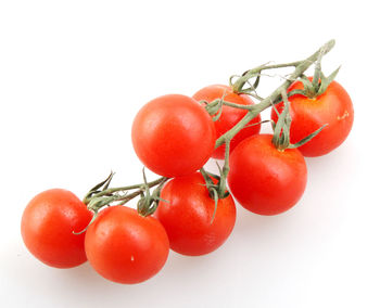 Close-up of cherry tomatoes against white background