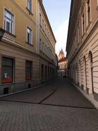 Empty alley amidst buildings in city