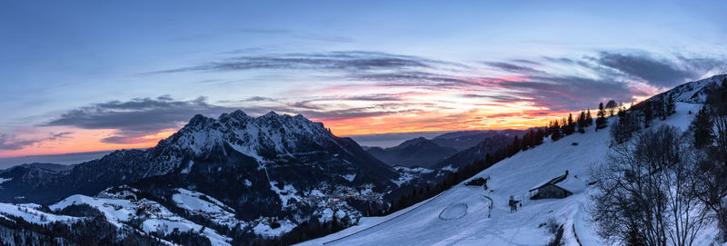 Scenic view of snowcapped mountains against sky during sunset