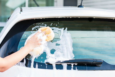 Cropped hand cleaning car 