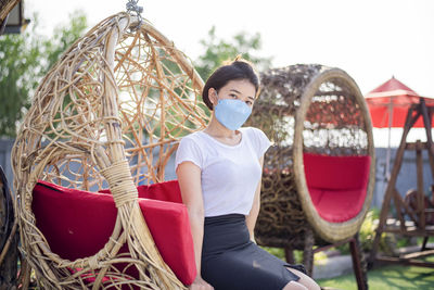 Asian girl wearing a mask detained and happy at home ,stay home away from society.