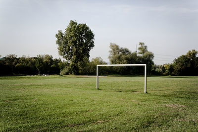 Soccer ball on field against sky