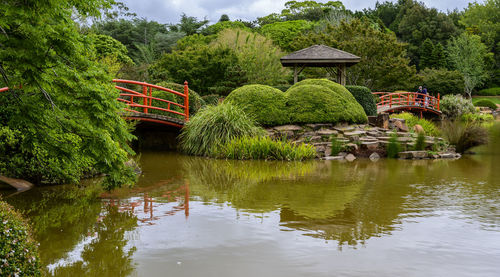 Gazebo by lake against trees