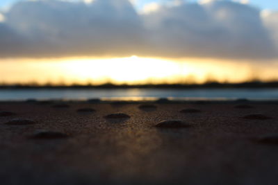 Close-up of sand at beach against sky